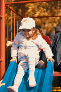 Cute girl sliding in playground