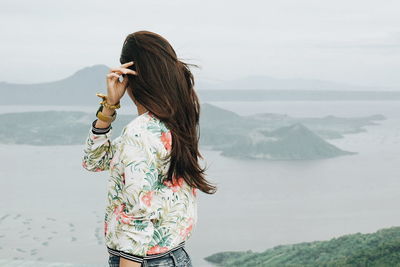 Side view of girl looking at view of taal volcano island