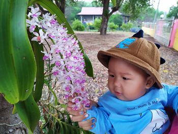 Portrait of cute boy with purple flowering plants