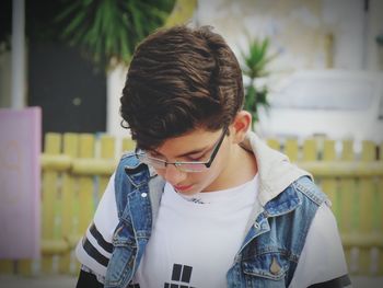 Close-up of boy in eyeglasses outdoors