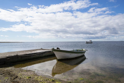 Boats moored on sea against sky