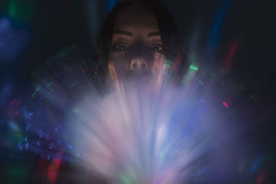 Portrait of woman in illuminated nightclub