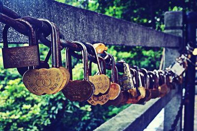 Close-up of padlocks on wooden post