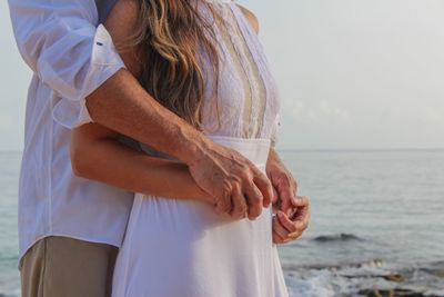 View of couple holding hands