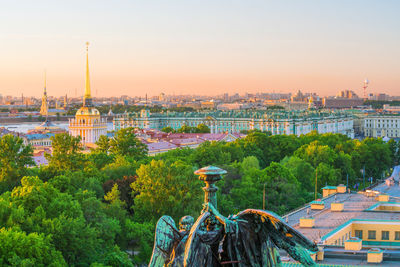 High angle view of buildings in city at sunset