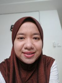 Close-up portrait of a smiling young woman