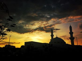 Low angle view of silhouette building against sky during sunset