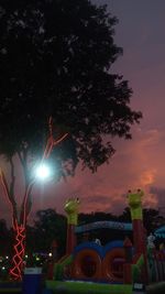 Low angle view of illuminated street against sky at night
