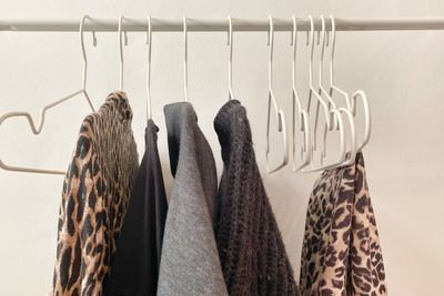 Close-up of clothes drying on clothesline against wall