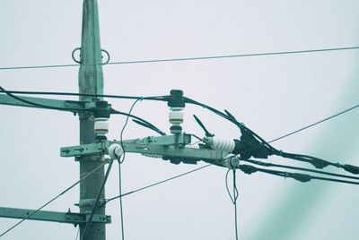 Low angle view of electricity pylon against sky