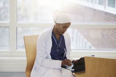 Young female doctor using tablet at work