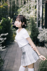 Woman standing in front of white flowering plants