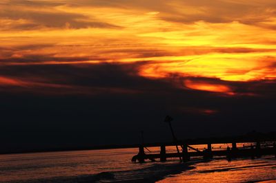 Silhouette pier on sea against sky during sunset