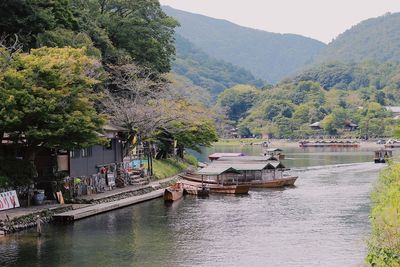 Scenic view of river and trees against mountains