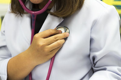 Midsection of woman checking heartbeats