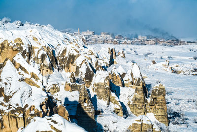 Panoramic view of snow covered mountains against sky