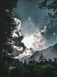 Scenic view of trees and mountains against sky