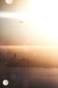 Scenic view of city against sky during sunset