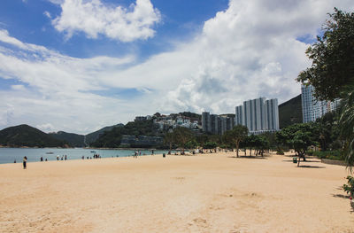 Panoramic view of beach and buildings against sky