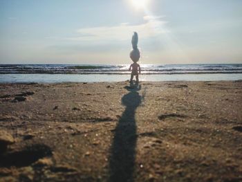 Man standing on beach against sky