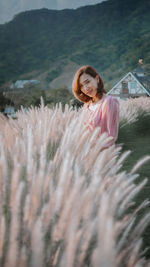 Portrait of smiling woman standing on field