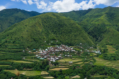 High angle view of agricultural field by buildings