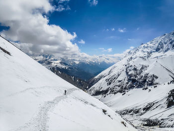 Scenic view of snow covered mountains against sky