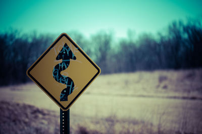 Close-up of road sign against clear sky