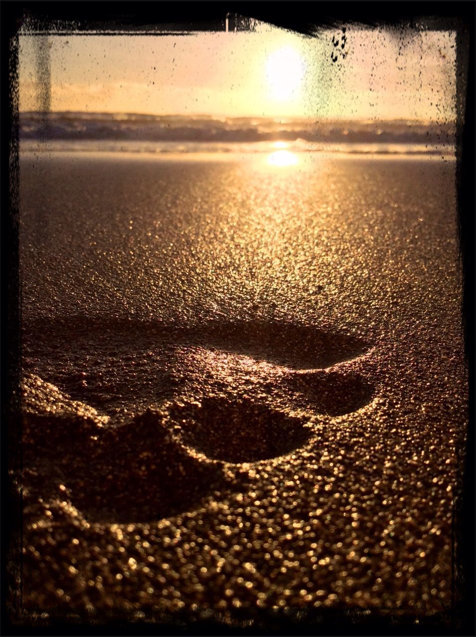 water, transfer print, sunset, sun, beach, auto post production filter, sunlight, surface level, wet, reflection, sand, shore, nature, sea, close-up, no people, outdoors, sunbeam, tranquility, lens flare