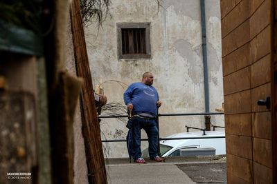 Rear view of man standing outside building