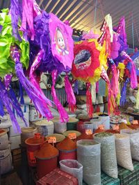 Multi colored umbrellas hanging for sale at market stall