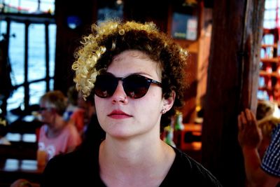 Close-up portrait of young woman wearing sunglasses