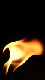 Close-up of fire over black background