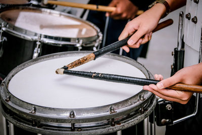 Cropped hands of man playing drum