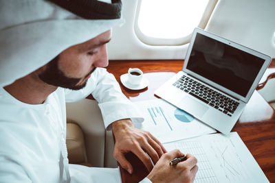 High angle view of businessman working in corporate jet