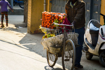 Low section of man selling fruits in market