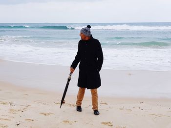 Full length of man standing on beach