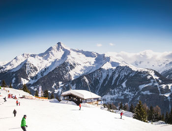 People skiing on snow covered mountain