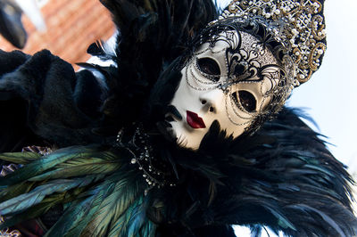 Close-up of person wearing venetian mask