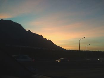 Scenic view of mountains against sky at sunset