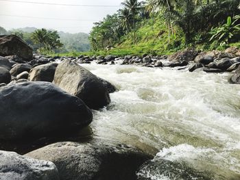 Scenic view of waterfall against sky