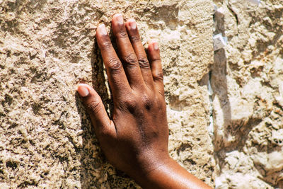 Close-up of person hand on sand