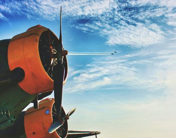 Low angle view of vintage airplanes against sky