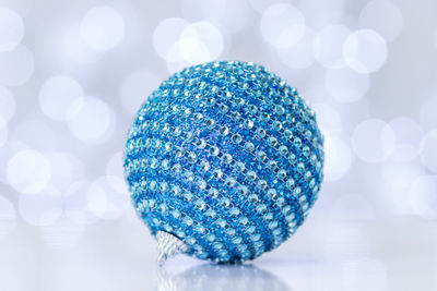 Blue christmas ornament on white table
