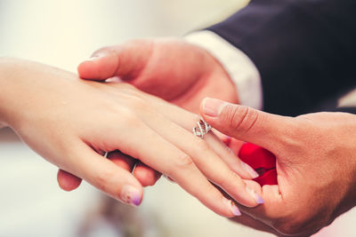 Midsection of couple holding hands