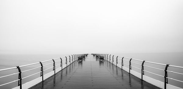 Pier over sea against clear sky