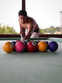 Portrait of man with balloons at home