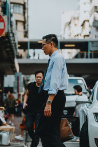 Man standing on street in city