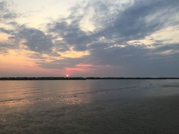 Scenic view of beach against sky during sunset