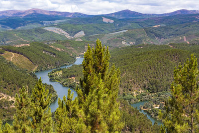 High angle view of lake amidst landscape against mountains